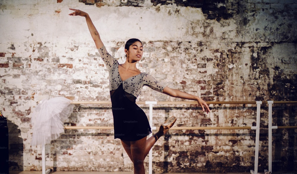 a woman in a black dress is dancing