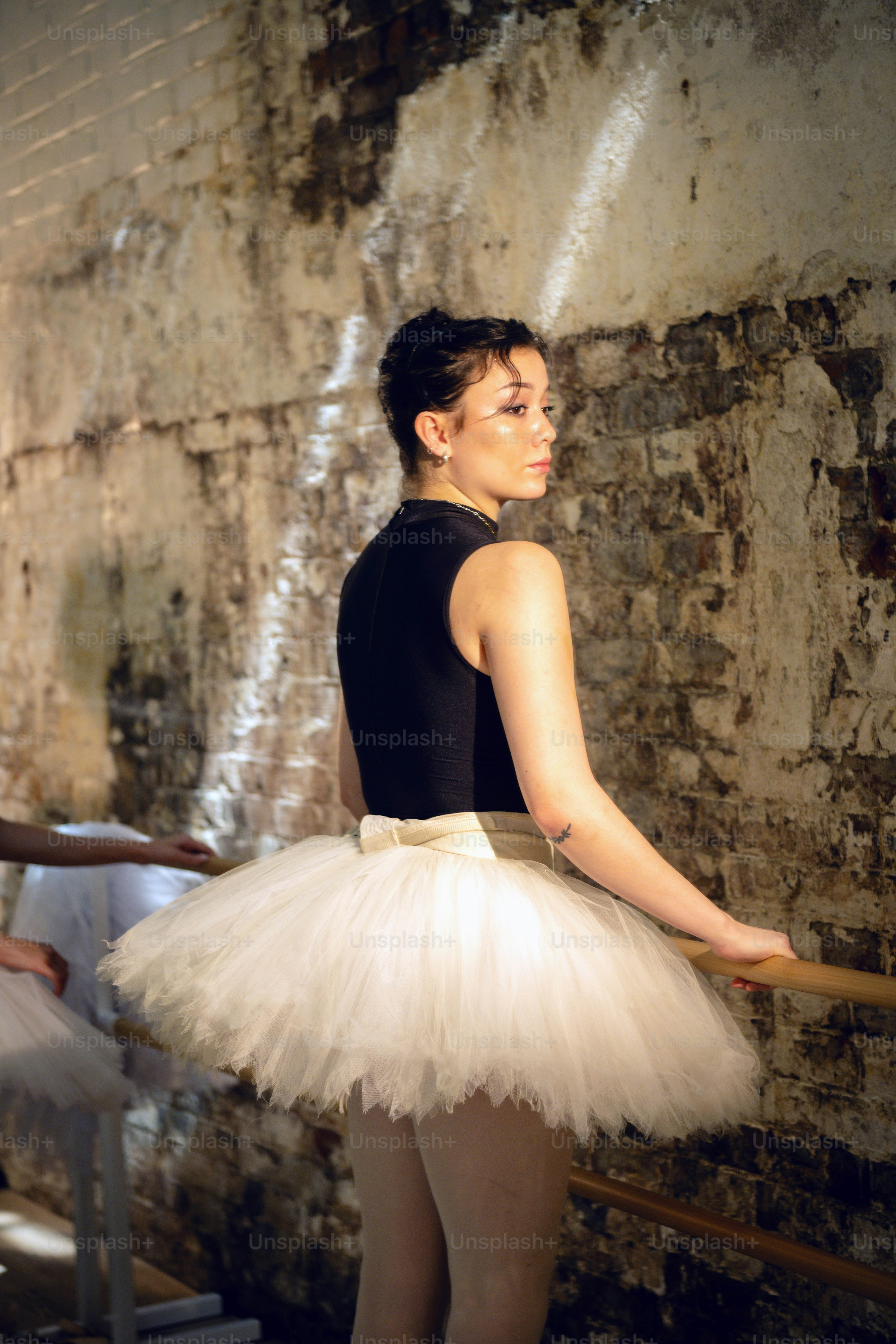 a woman in a black top and a white tutu
