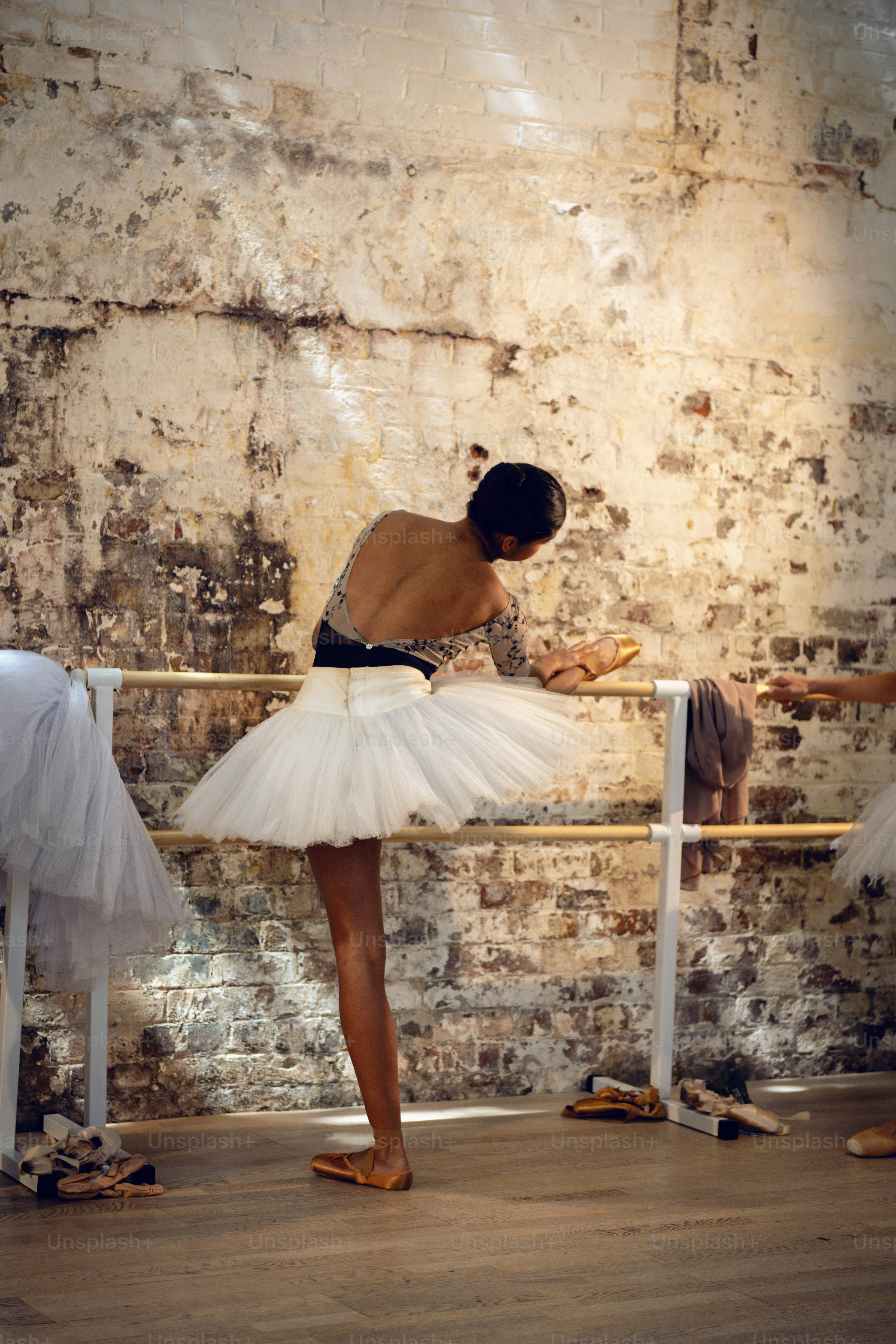 a woman in a white tutu and a man in a black shirt