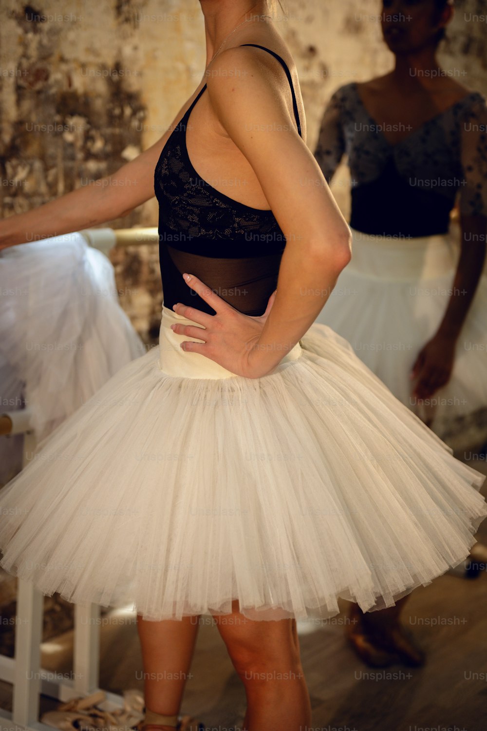 a woman wearing a white tutu and a black top