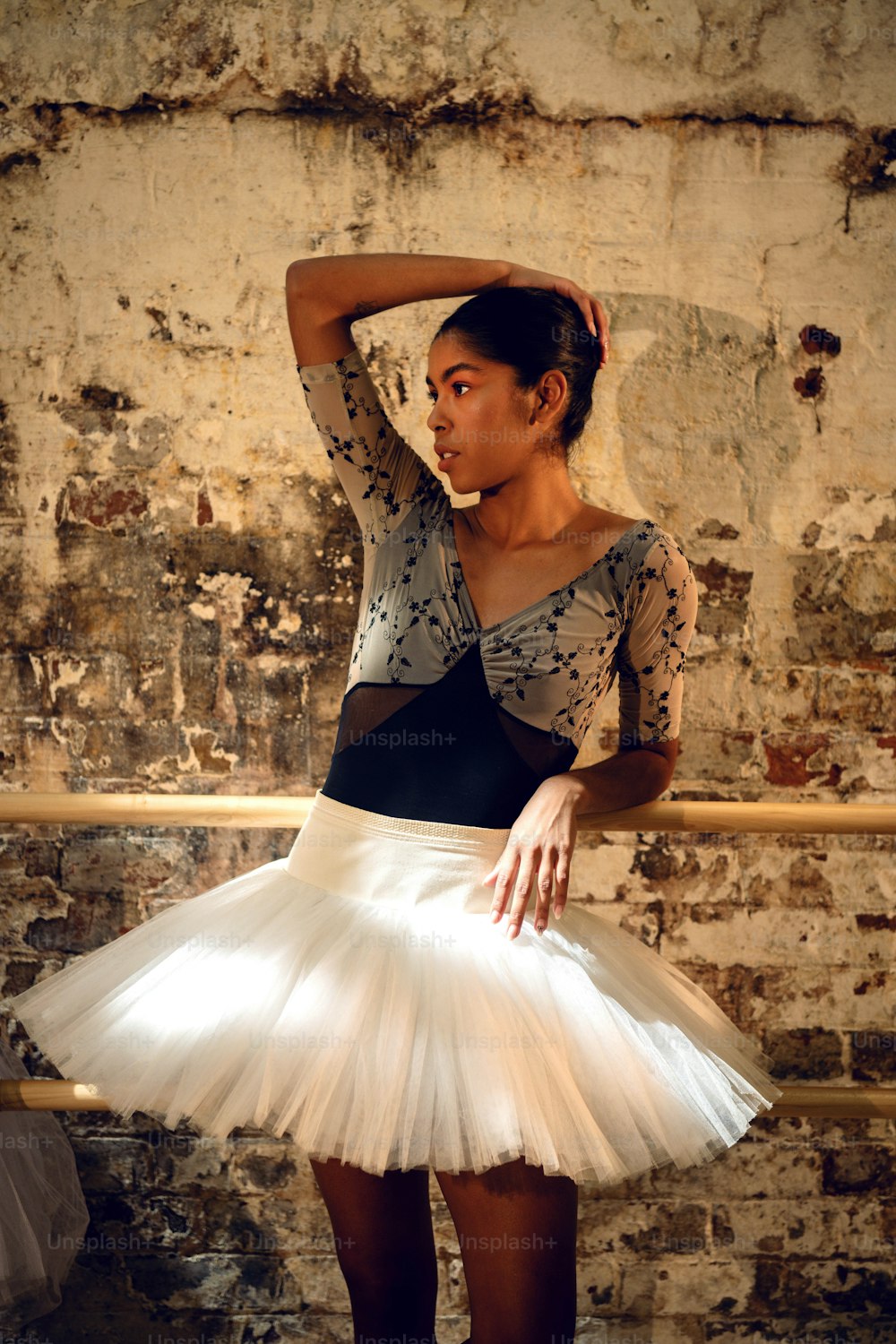 a woman in a white tutu is posing for a picture