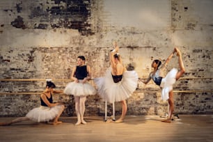 a group of ballerinas standing around each other