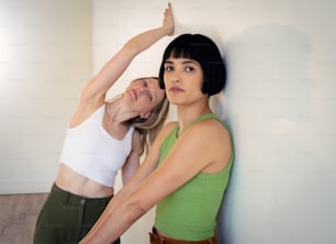 two women standing next to each other in a room