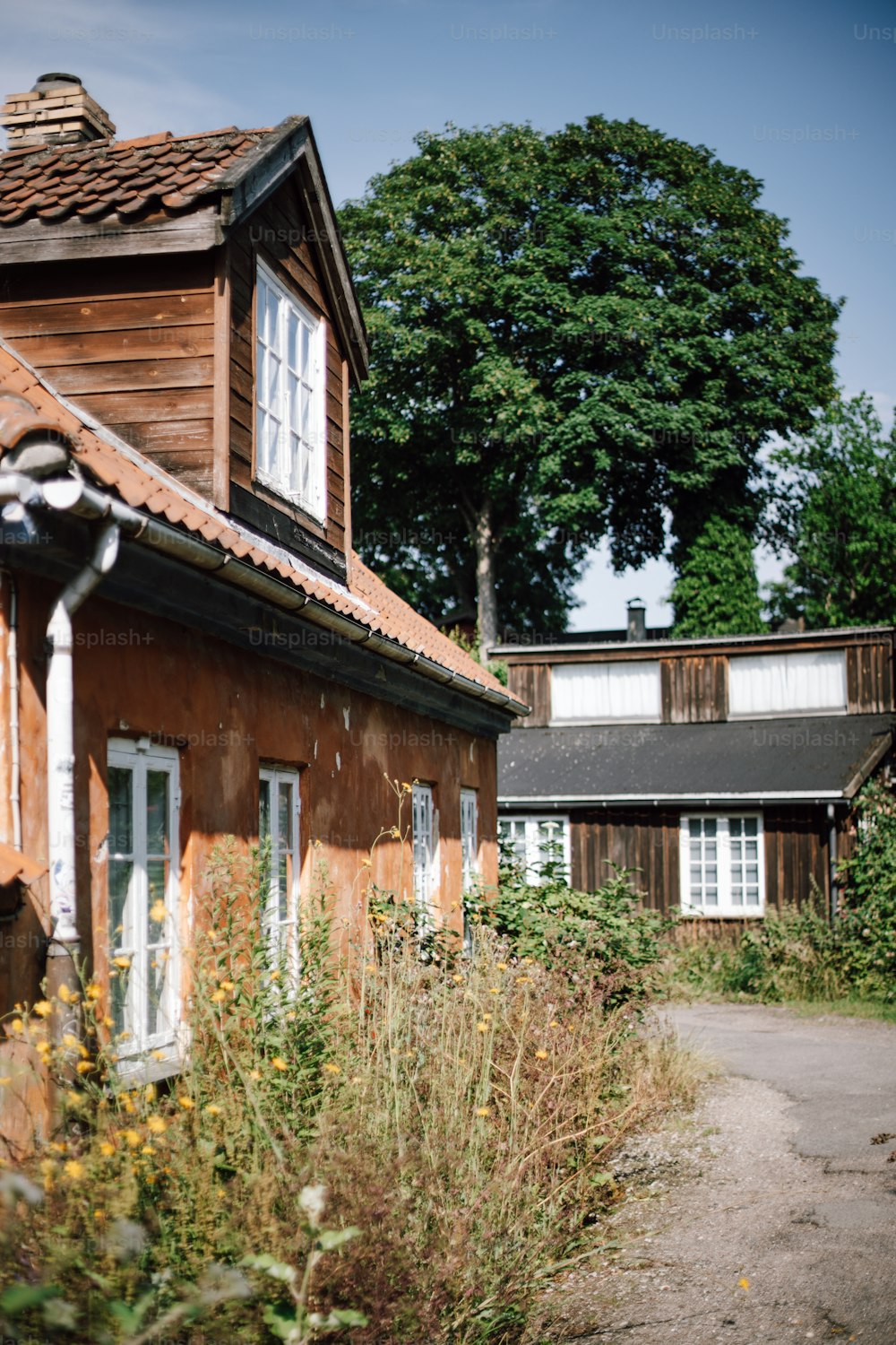 an old run down house with a red roof