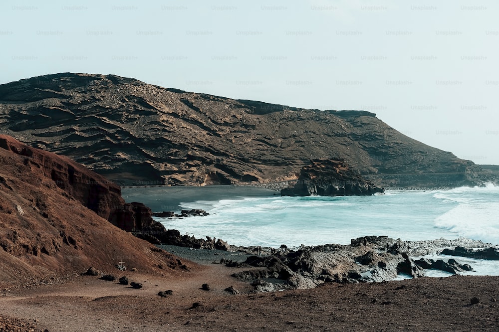 a view of the ocean from a rocky cliff