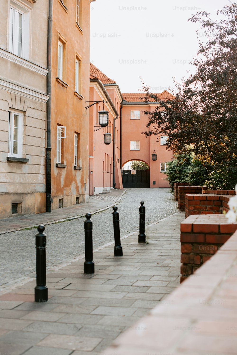 a row of black poles sitting on the side of a road