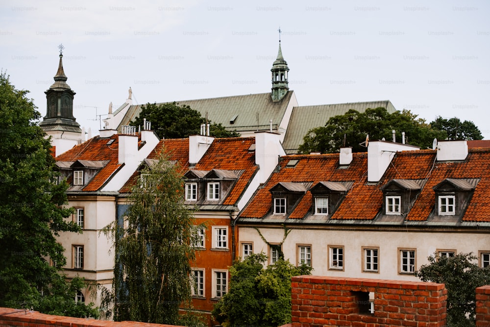 a row of buildings with red tiled roofs