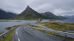 a winding road with a mountain in the background