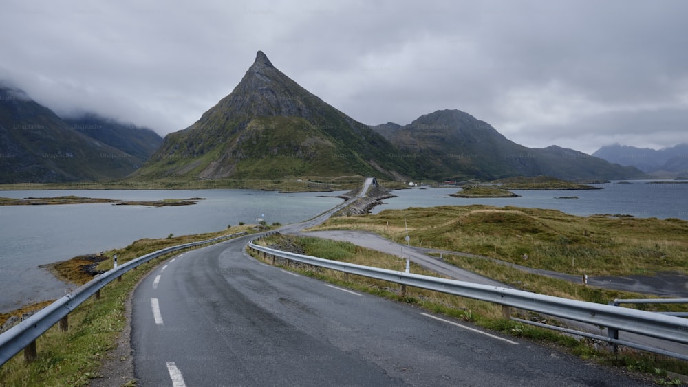 a winding road with a mountain in the background