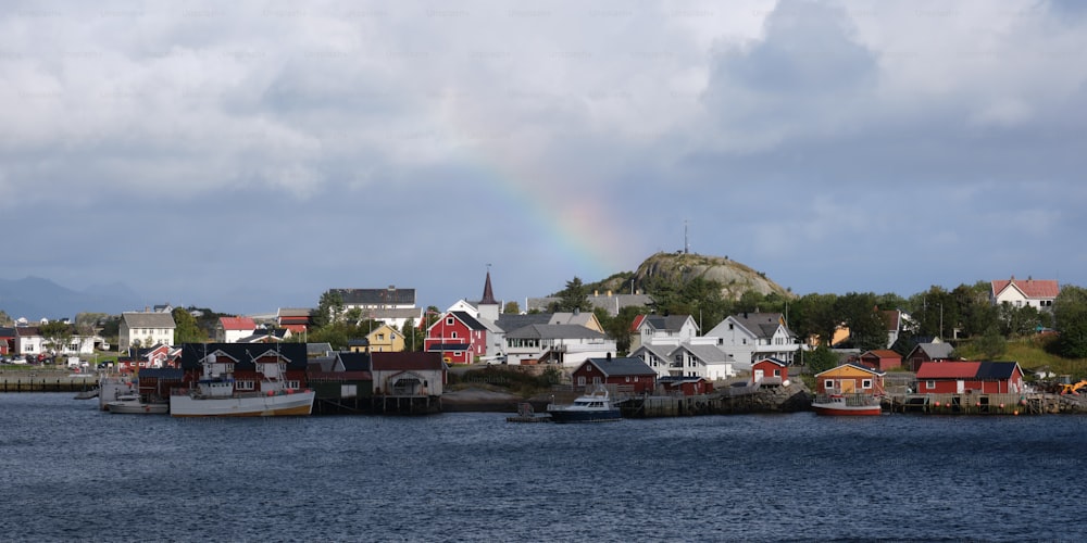 a rainbow in the sky over a small town