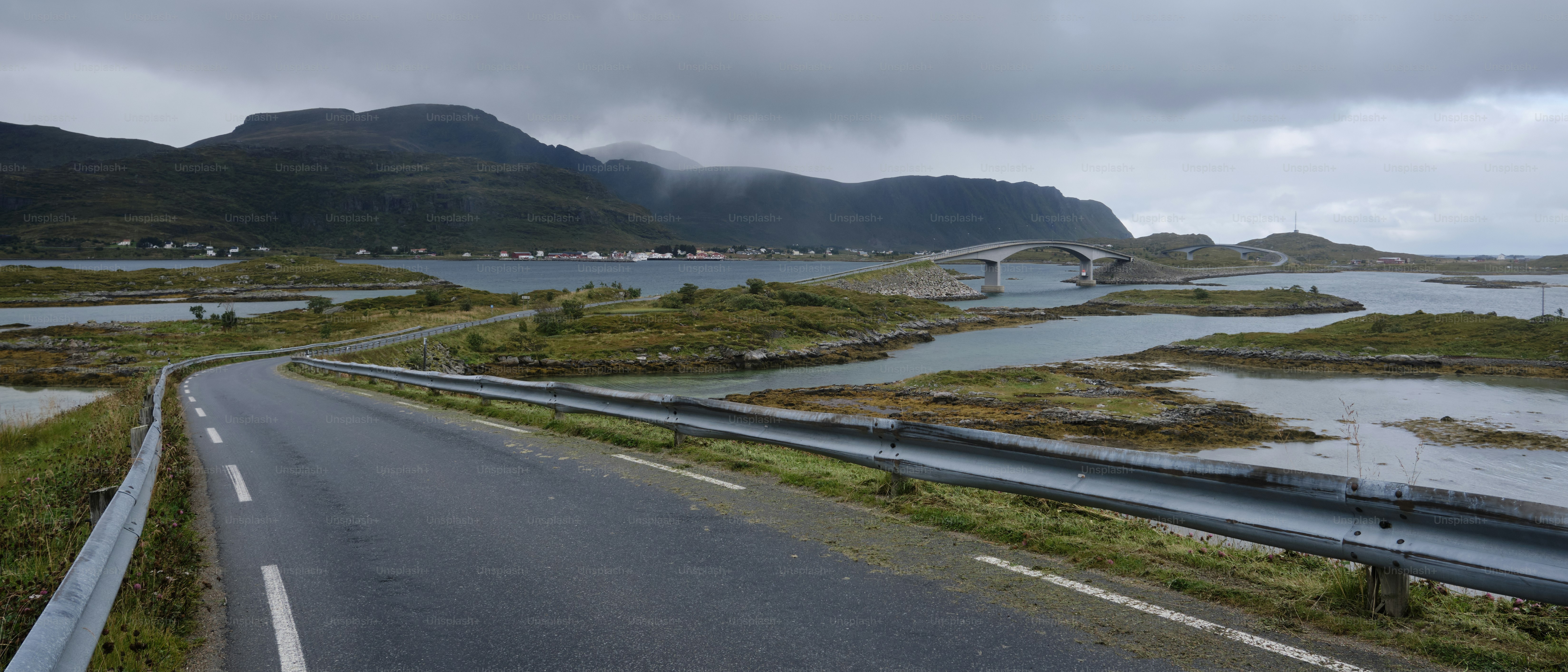 a road with a bridge over a body of water