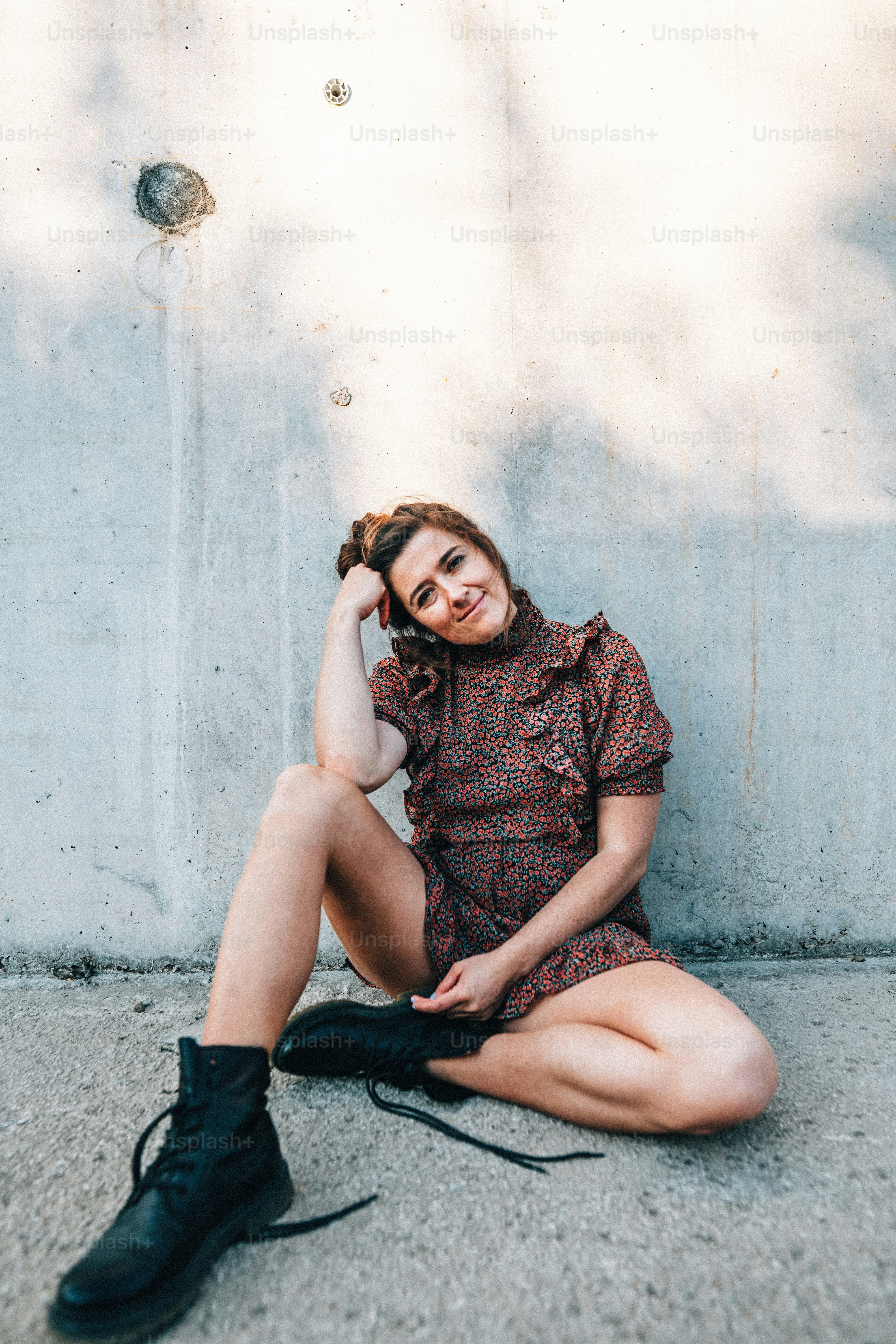 a woman sitting on the ground with her legs crossed