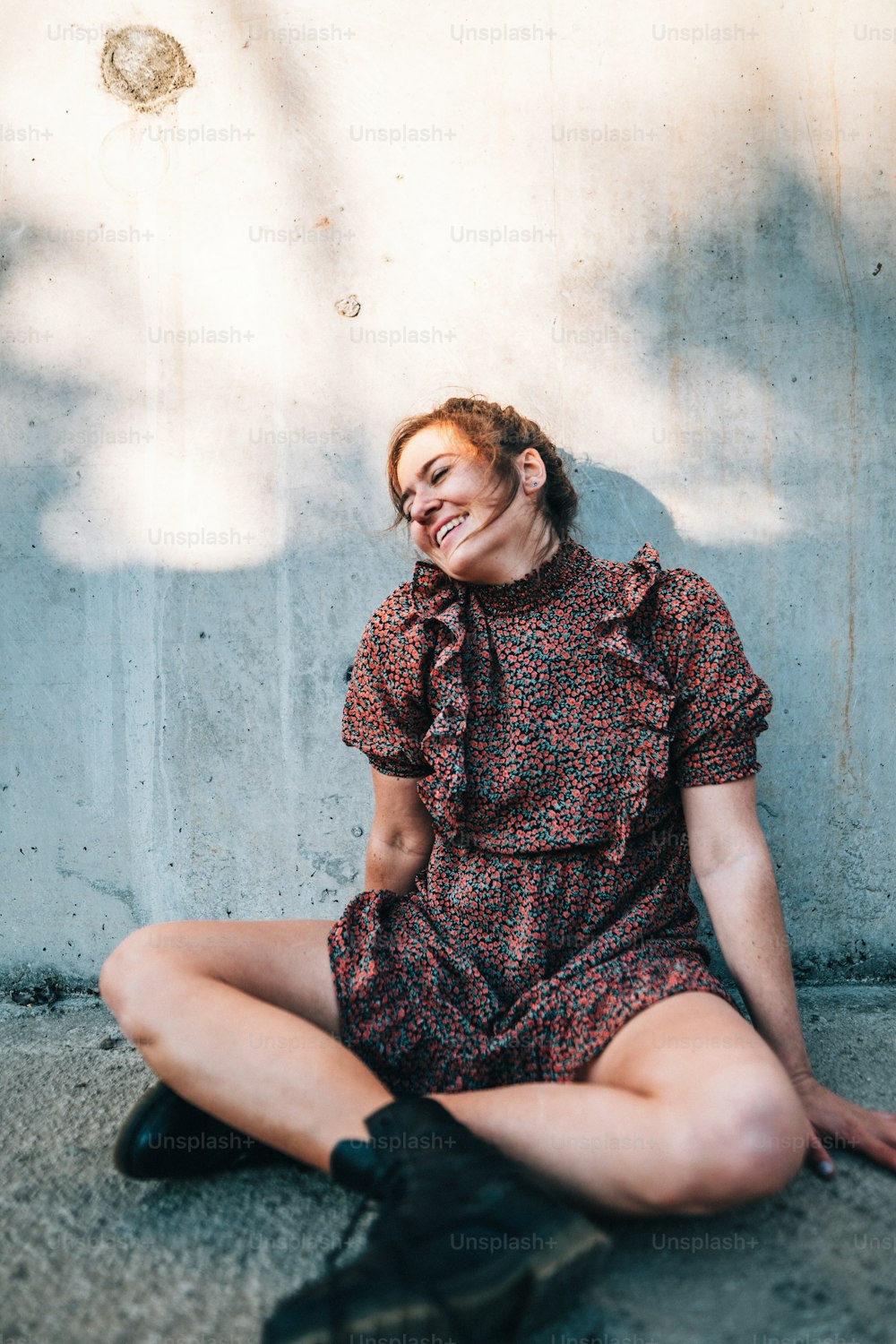 a woman sitting on the ground laughing