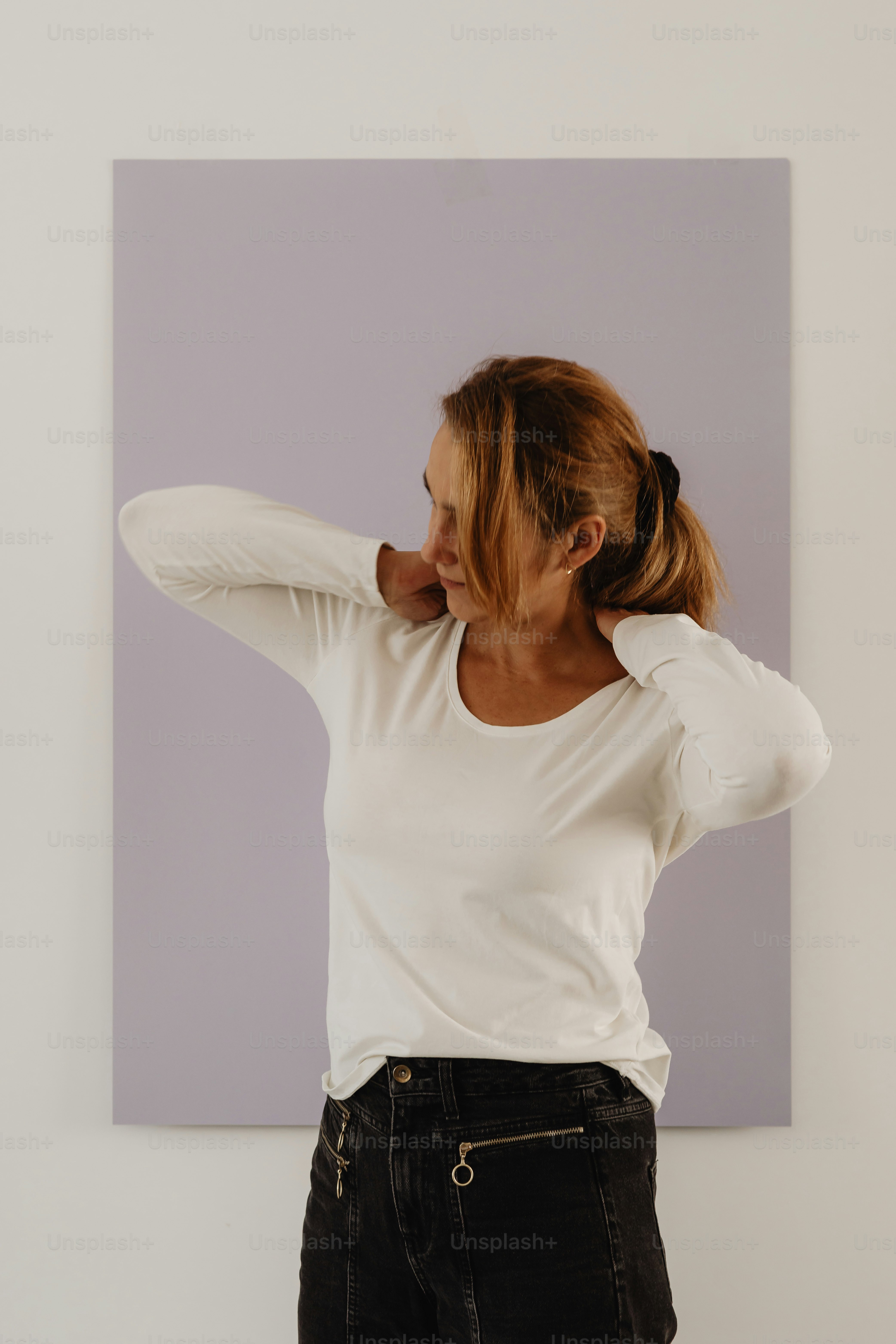 A woman standing in front of a painting photo – Basic fashion Image on ...