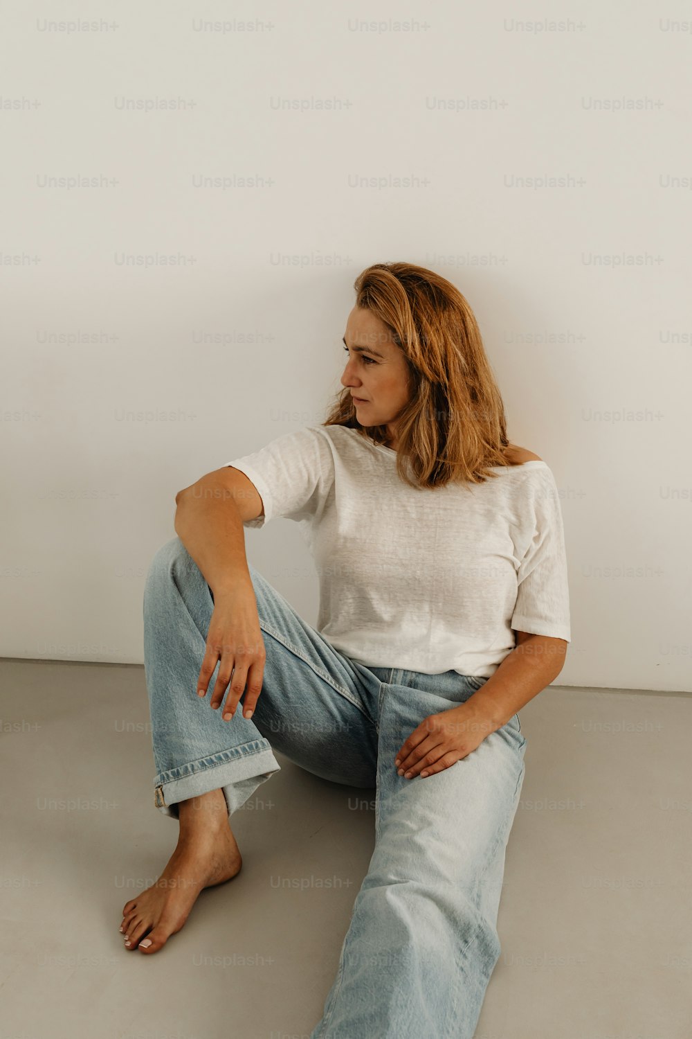 a woman sitting on the floor with her legs crossed