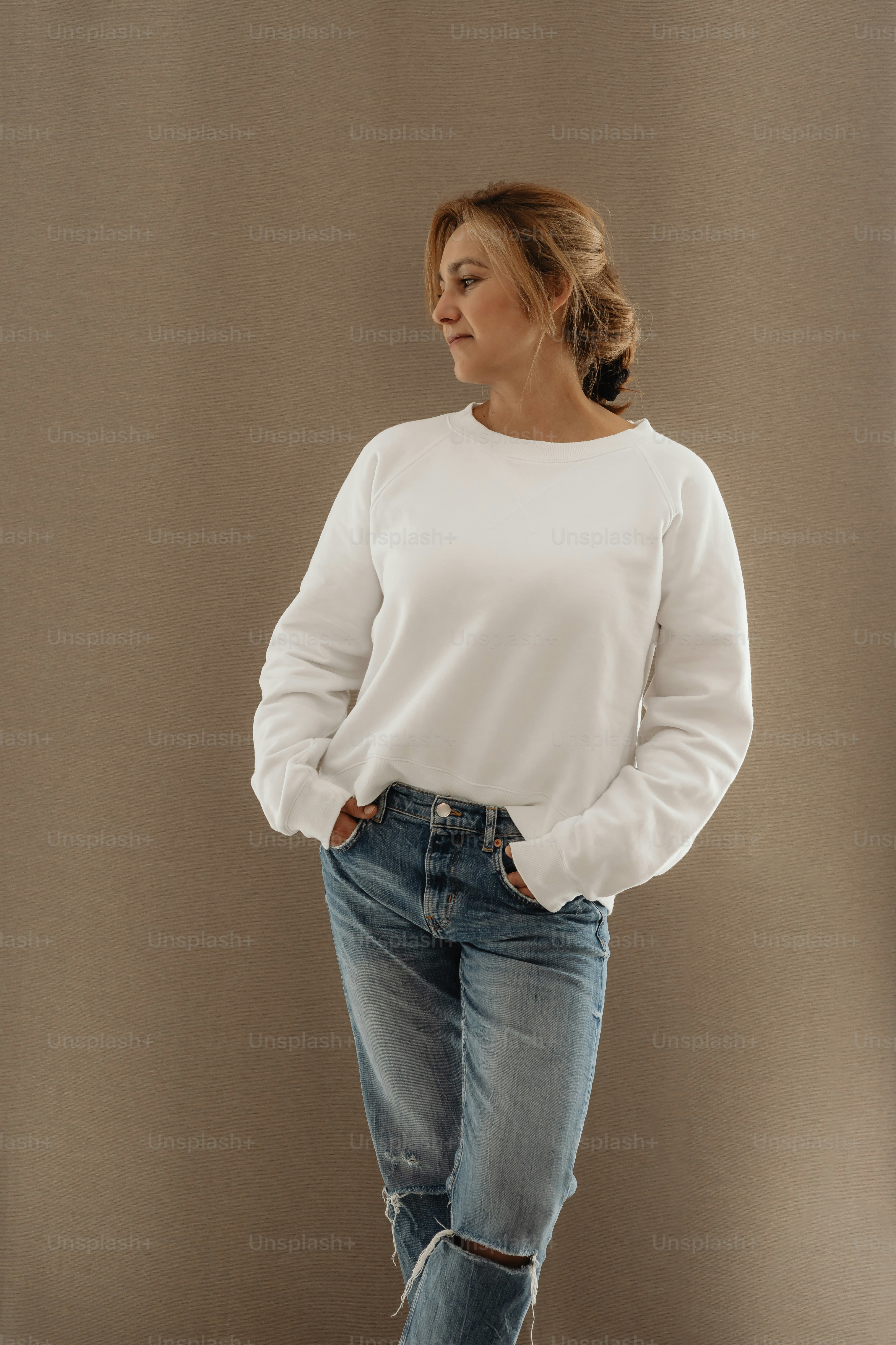 a woman in a white shirt and jeans