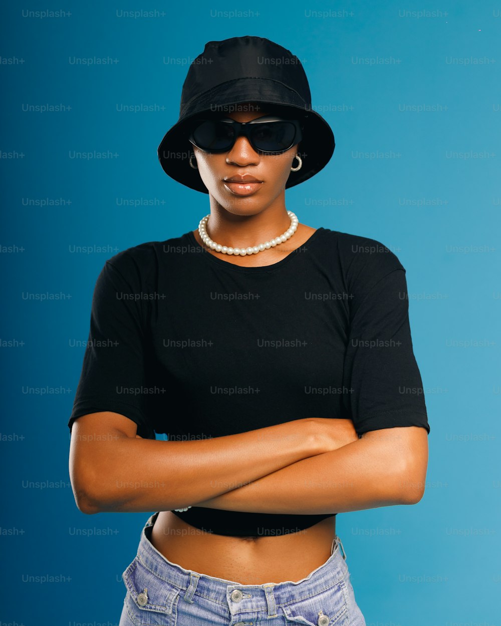 a woman wearing a black hat and sunglasses