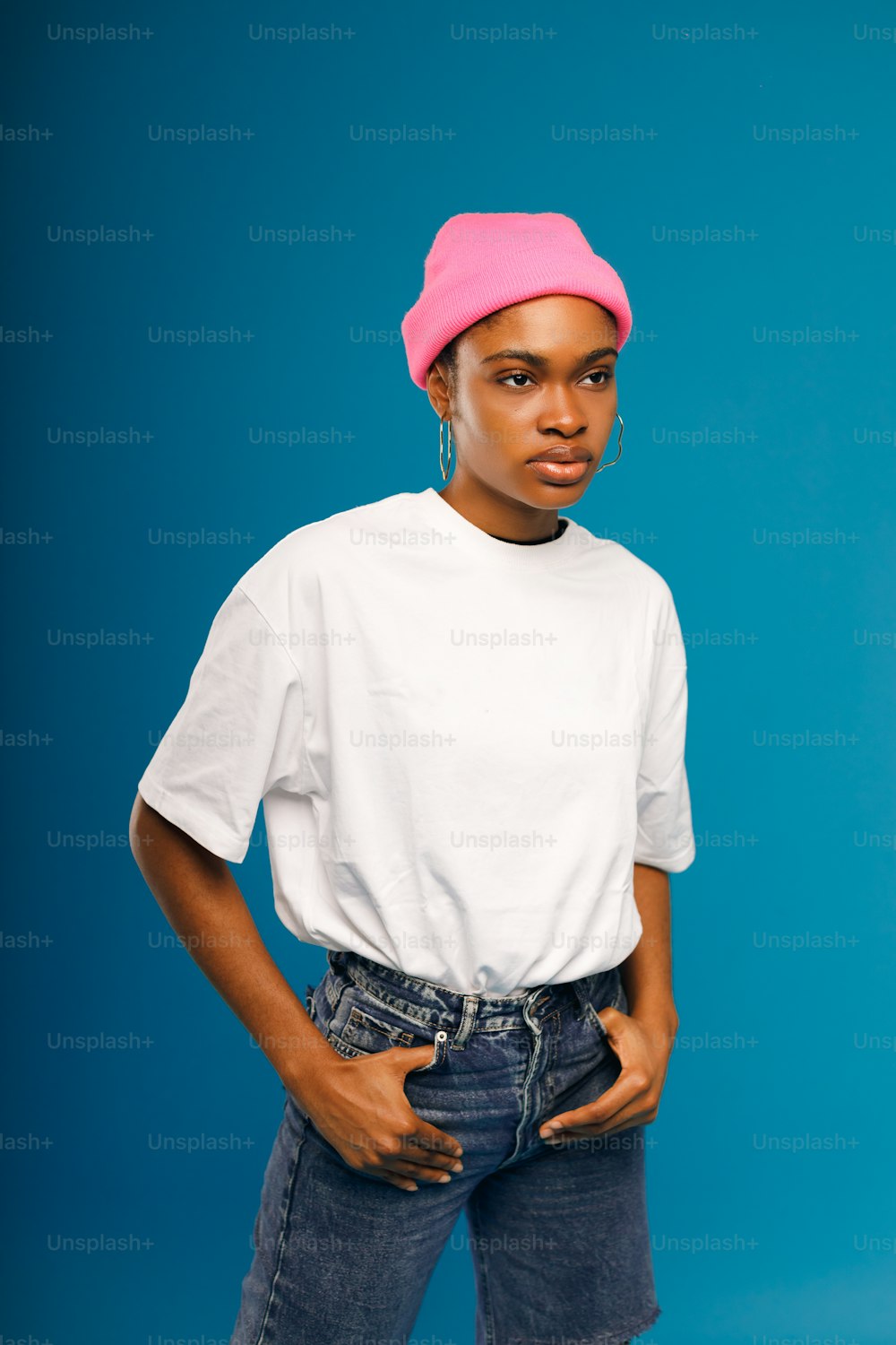 a woman in a white shirt and a pink hat