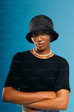 a woman wearing a black hat and a black shirt
