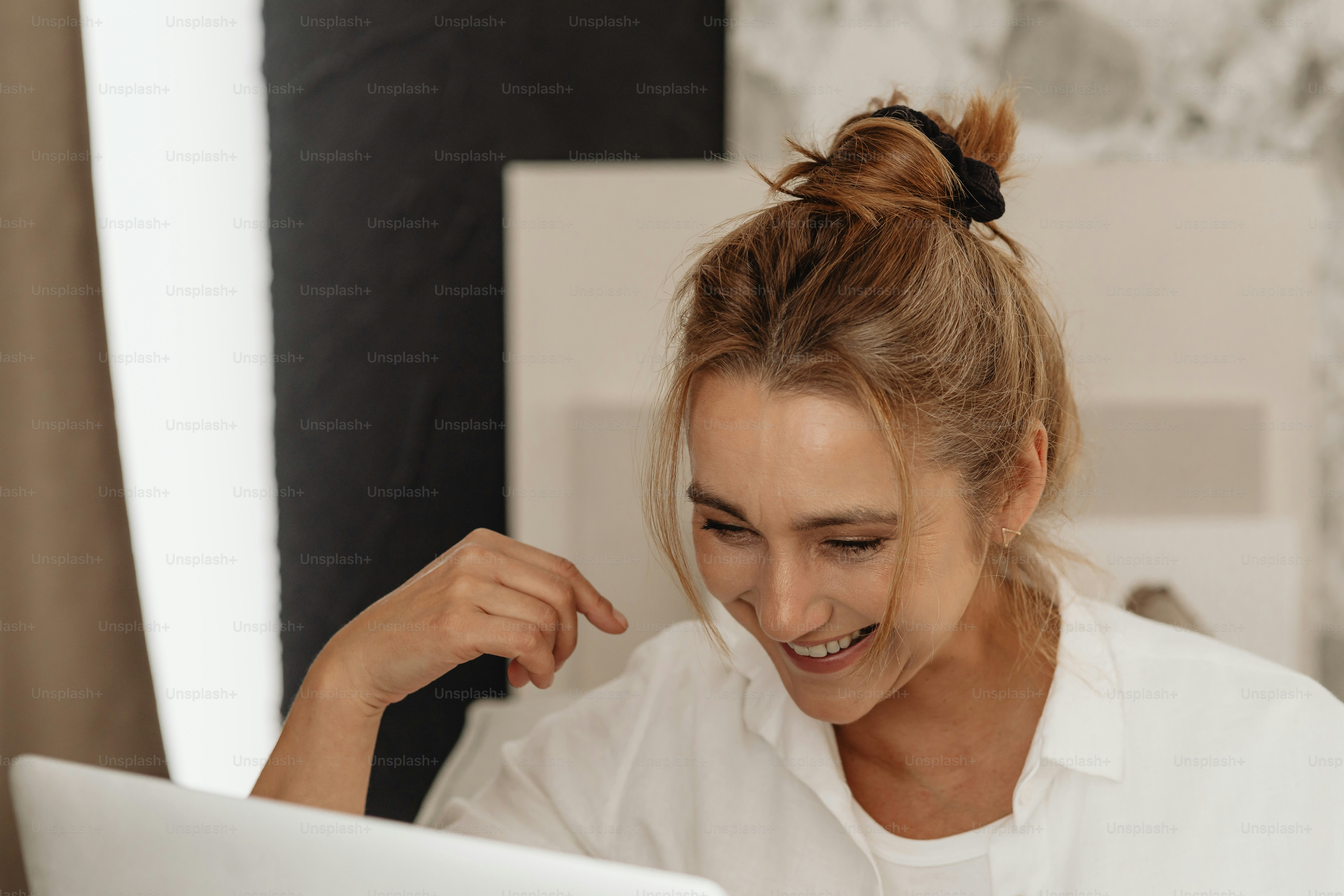 A woman sitting in front of a laptop computer photo – Positive Image on ...