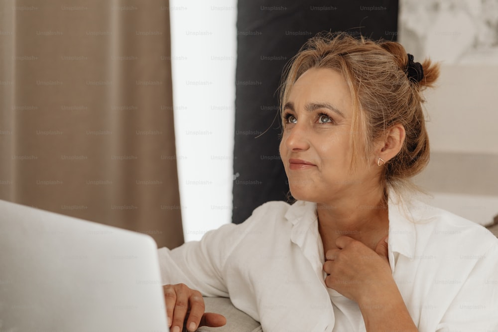 a woman sitting in front of a laptop computer