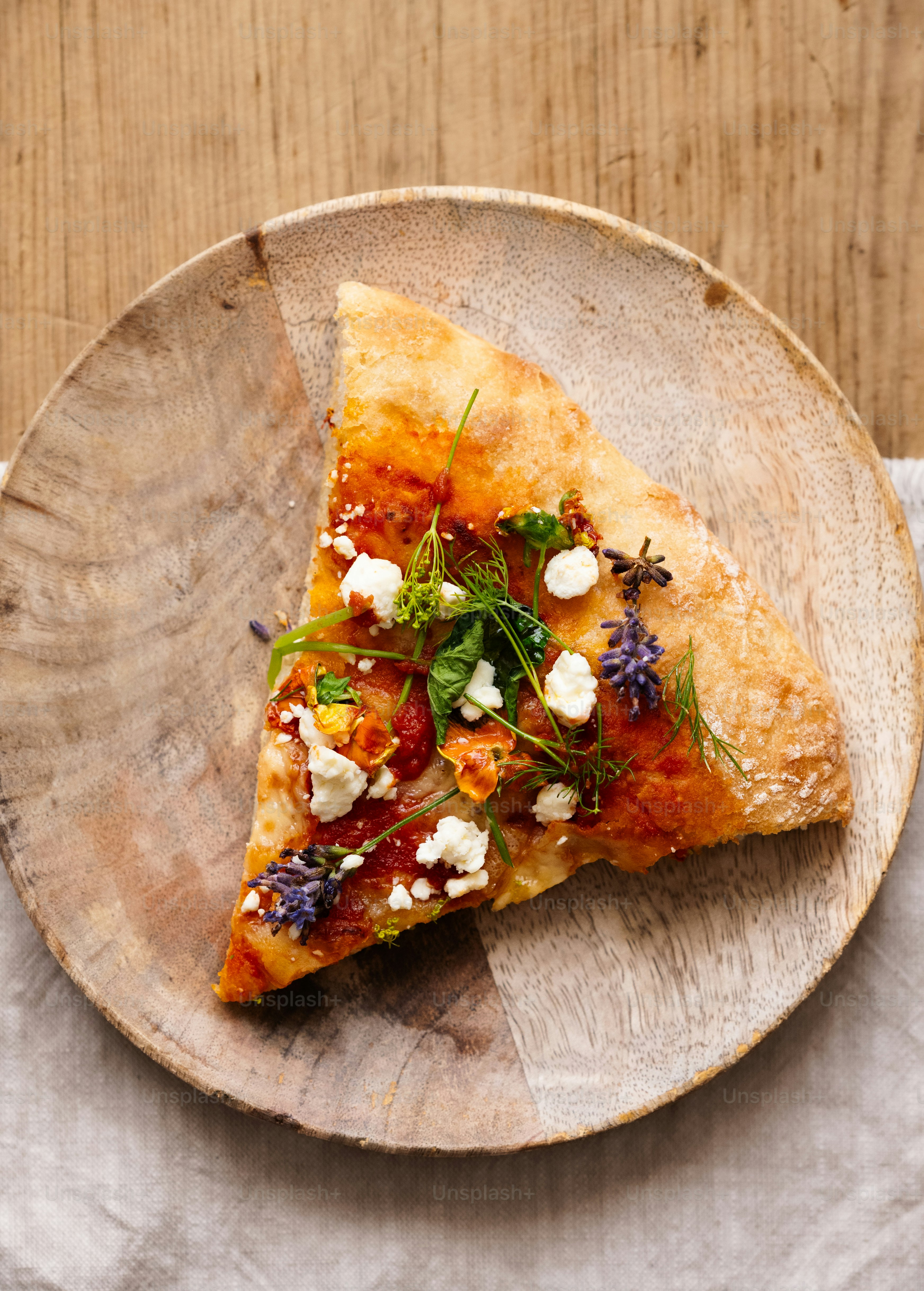 a slice of pizza on a plate on a table