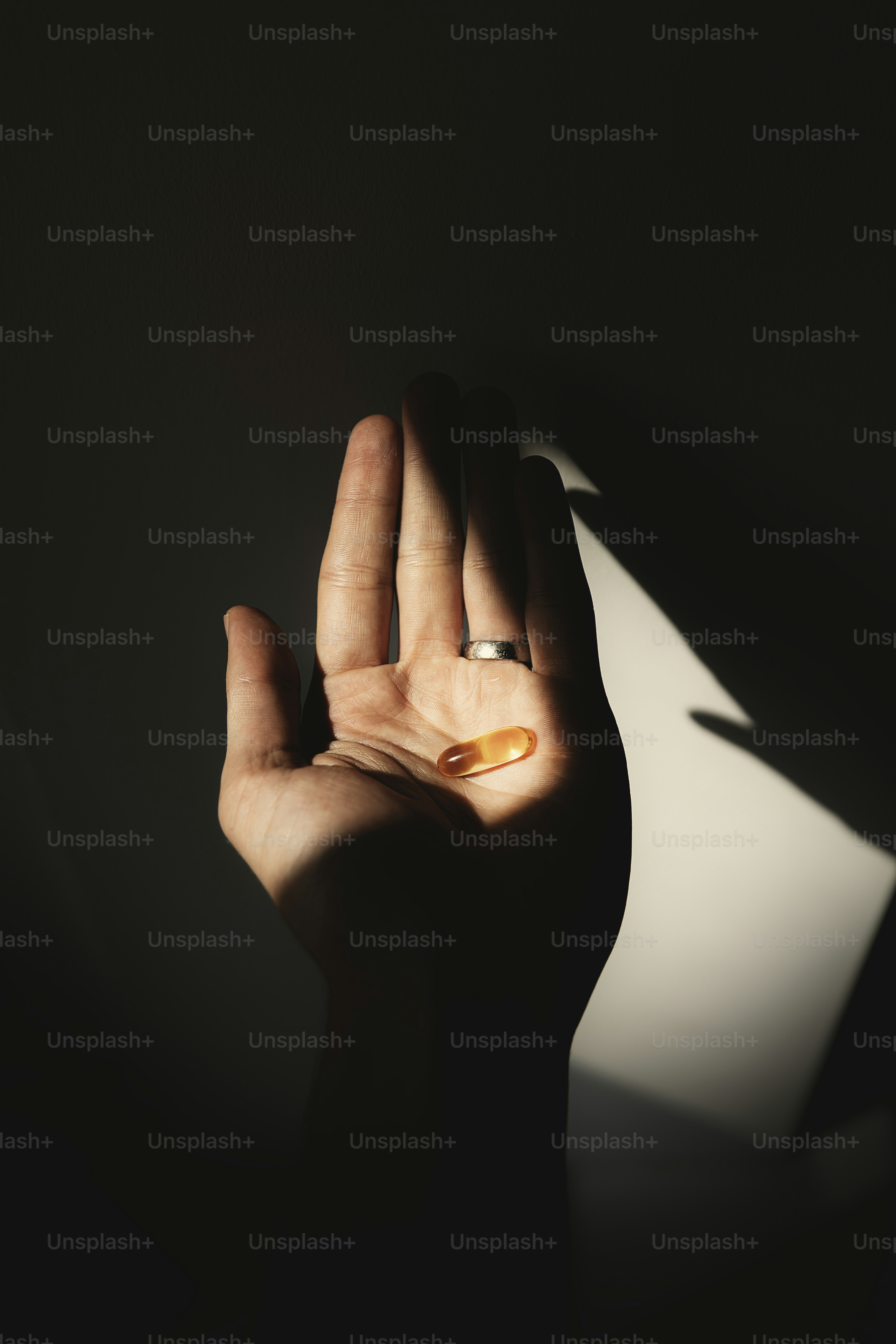 a person holding a pill pill in their hand