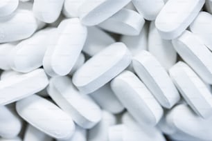 a pile of white pills sitting on top of each other