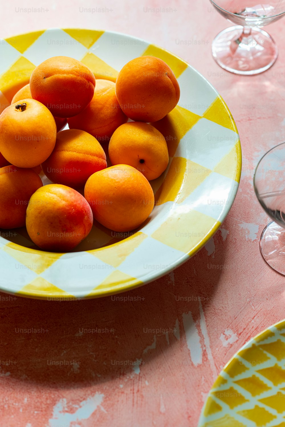 a bowl of apricots sitting on a table