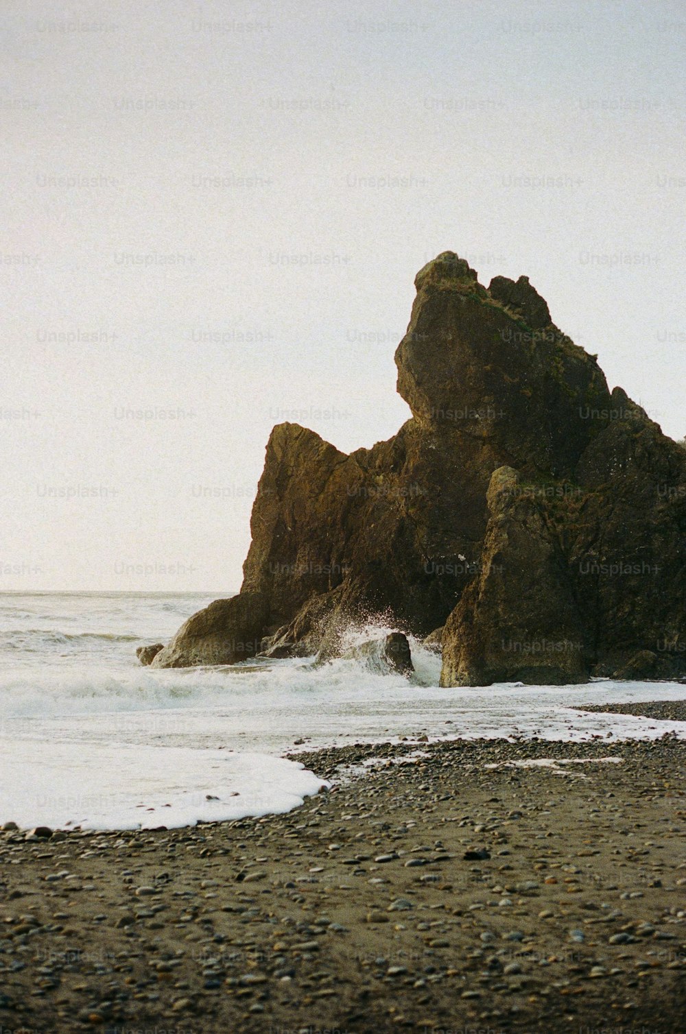 a person walking on a beach with a surfboard