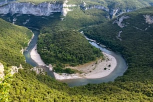 a river flowing through a lush green valley