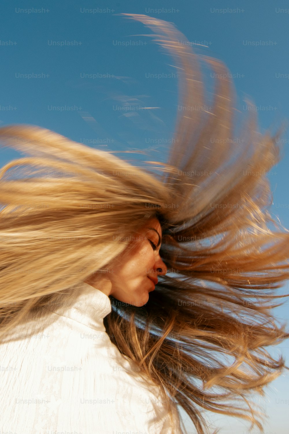 a woman with her hair blowing in the wind