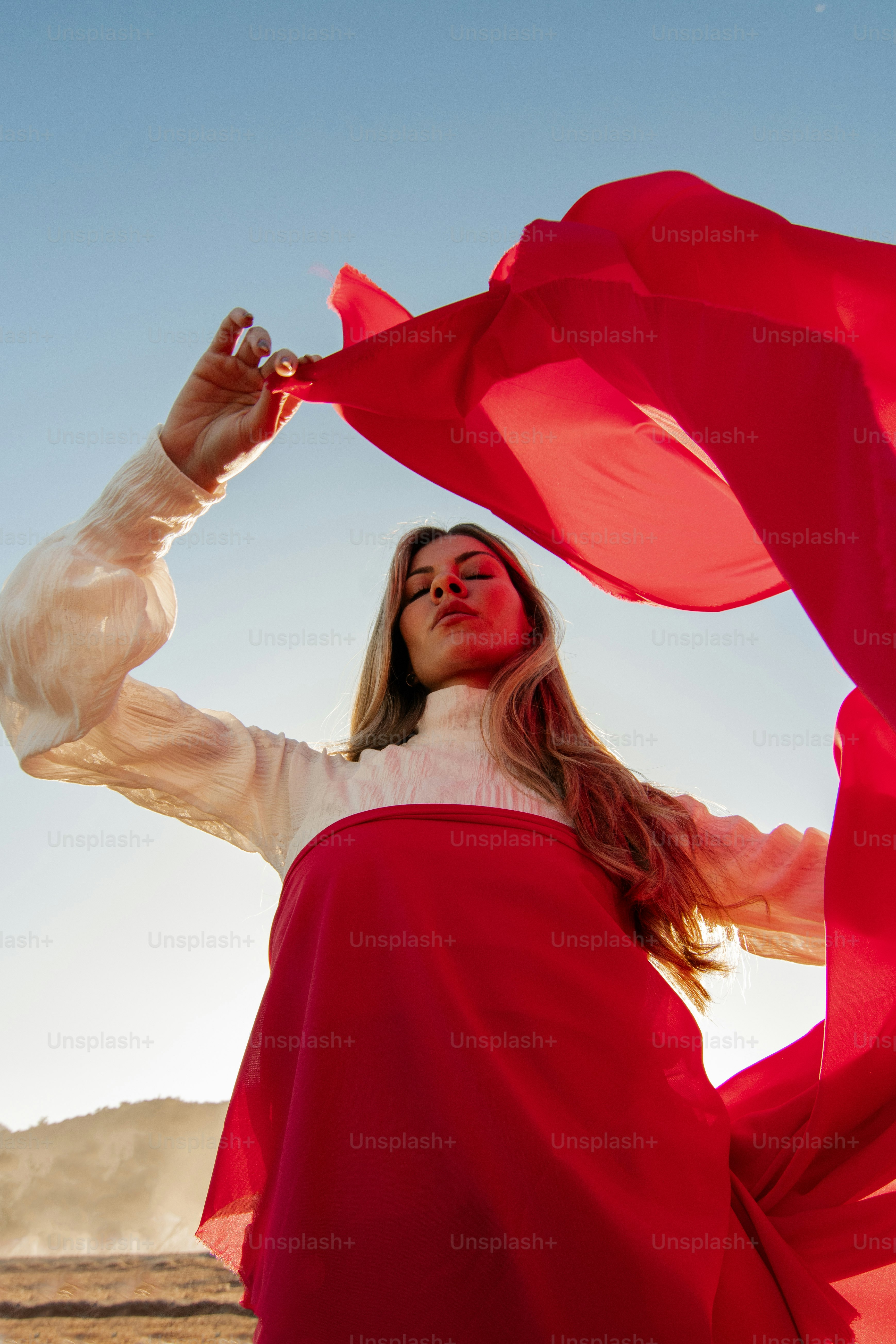 a woman in a red dress with a red scarf around her neck