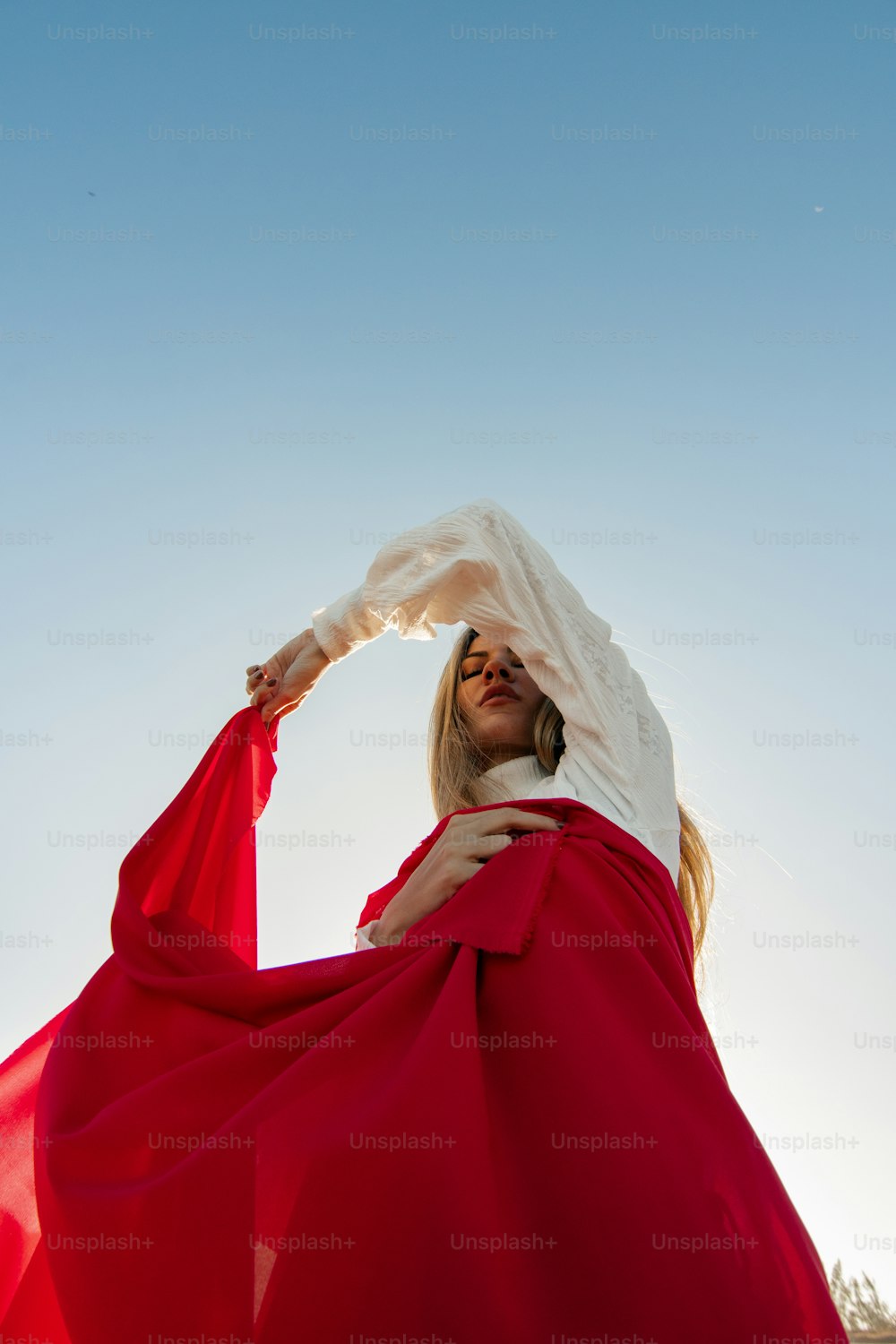 a woman in a red dress is posing for a picture