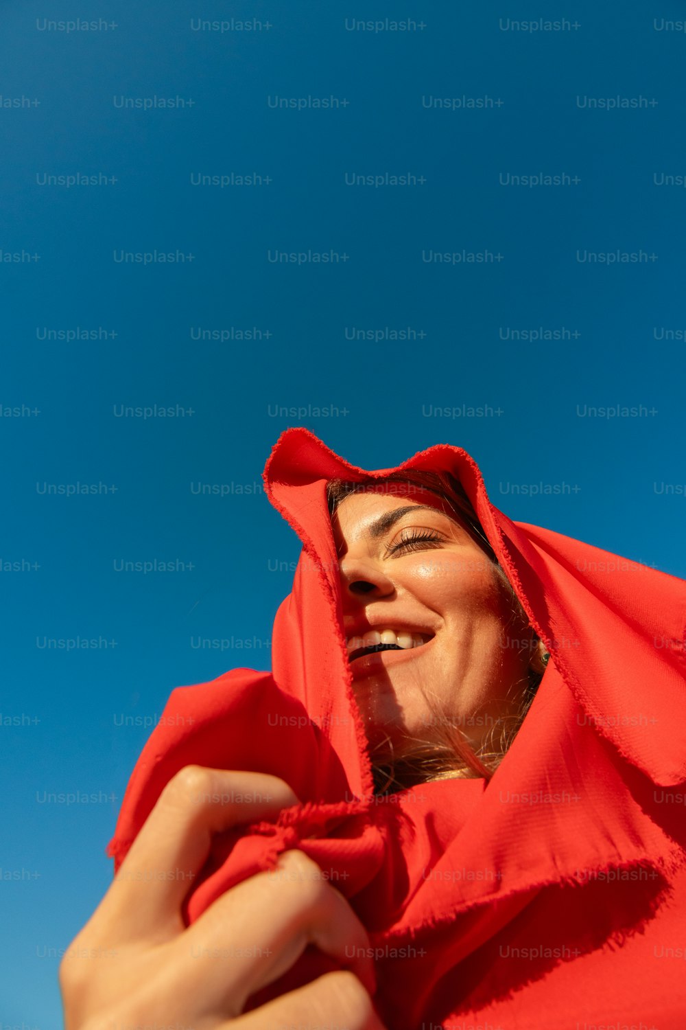 a woman in a red hoodie is smiling
