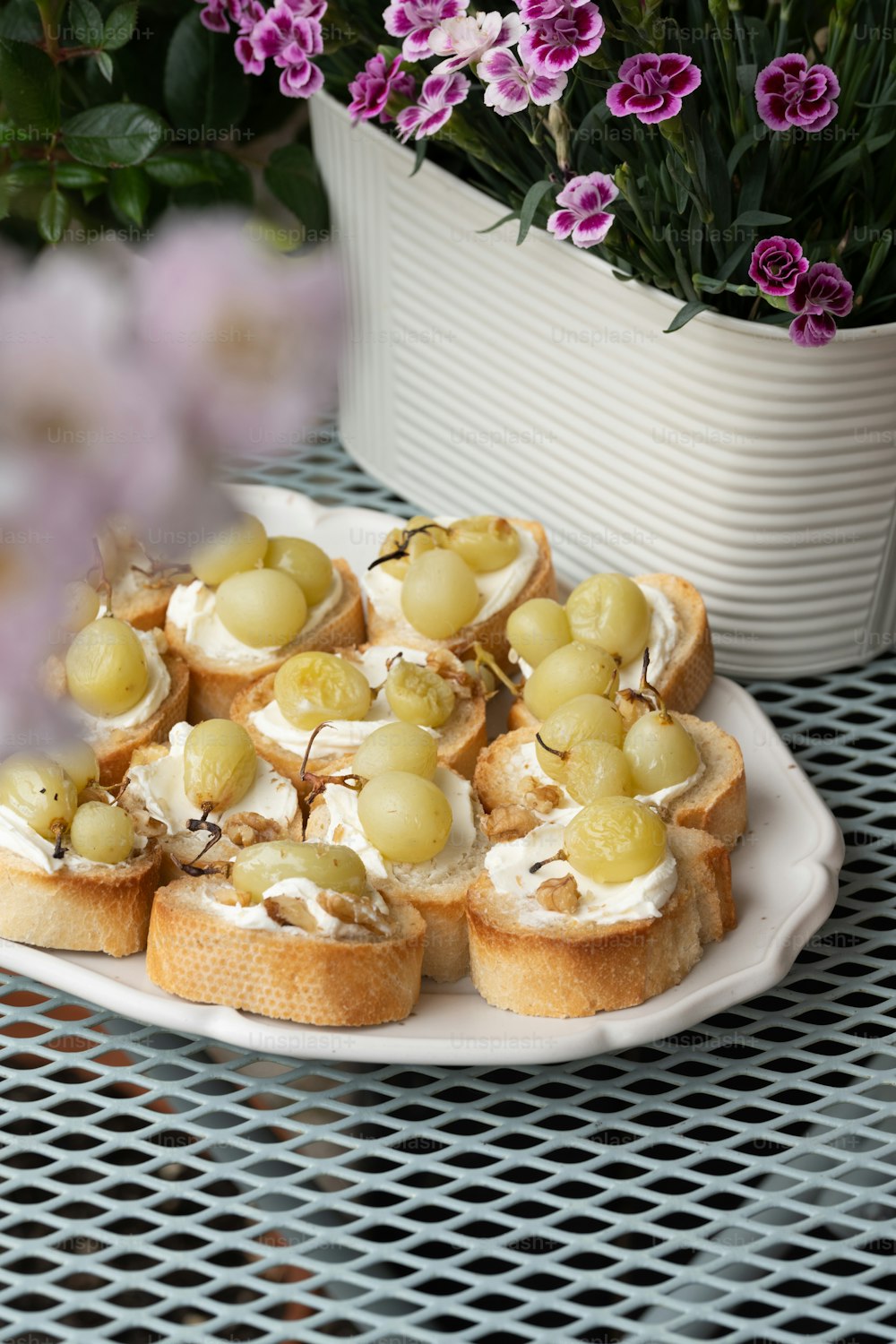 a white plate topped with grapes and crackers