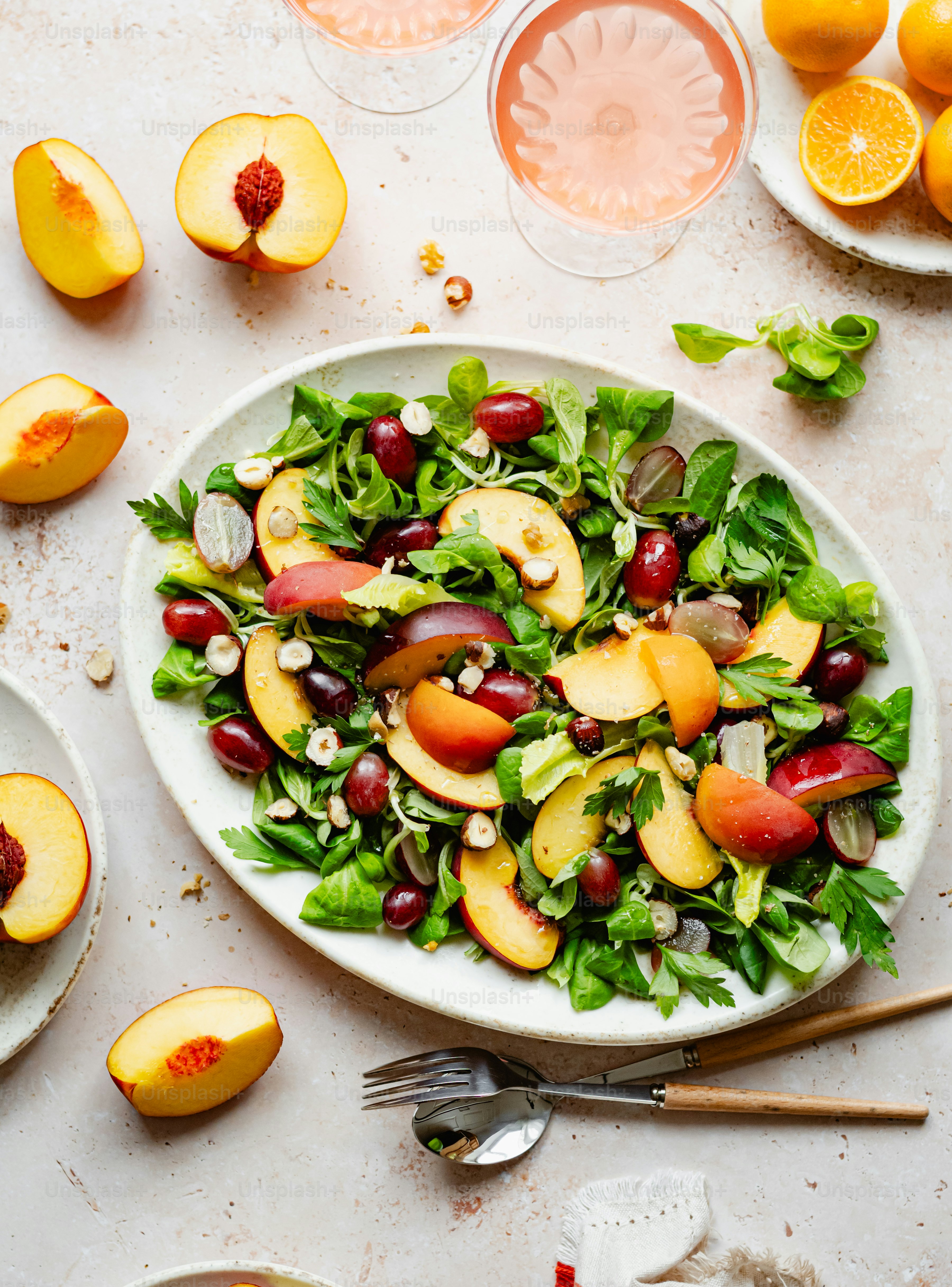 a white plate topped with a salad covered in fruit