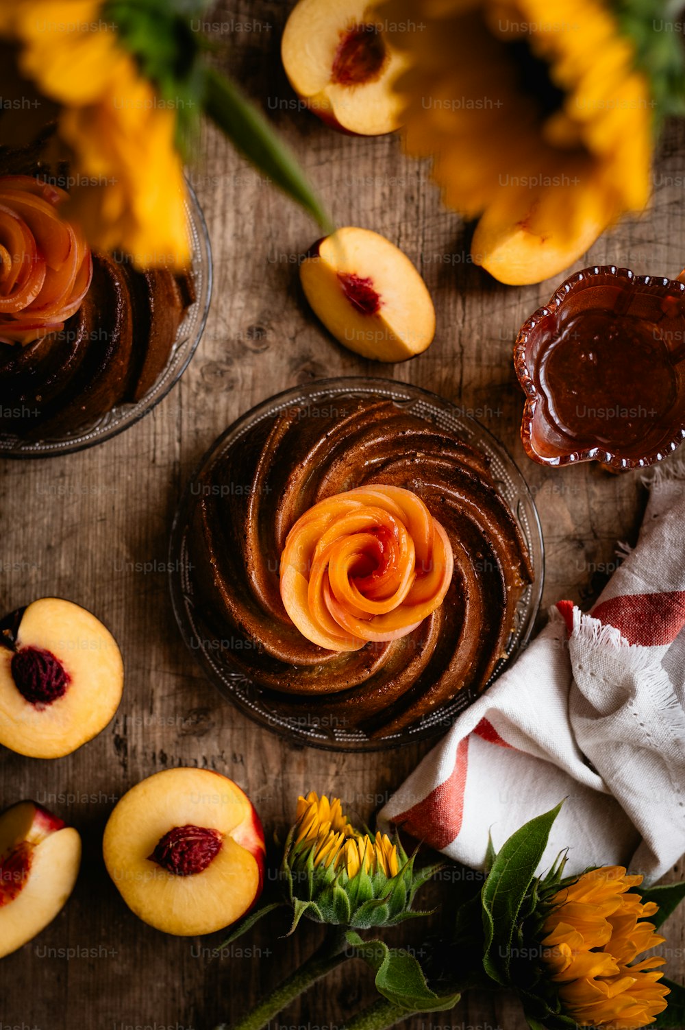a wooden table topped with desserts and flowers
