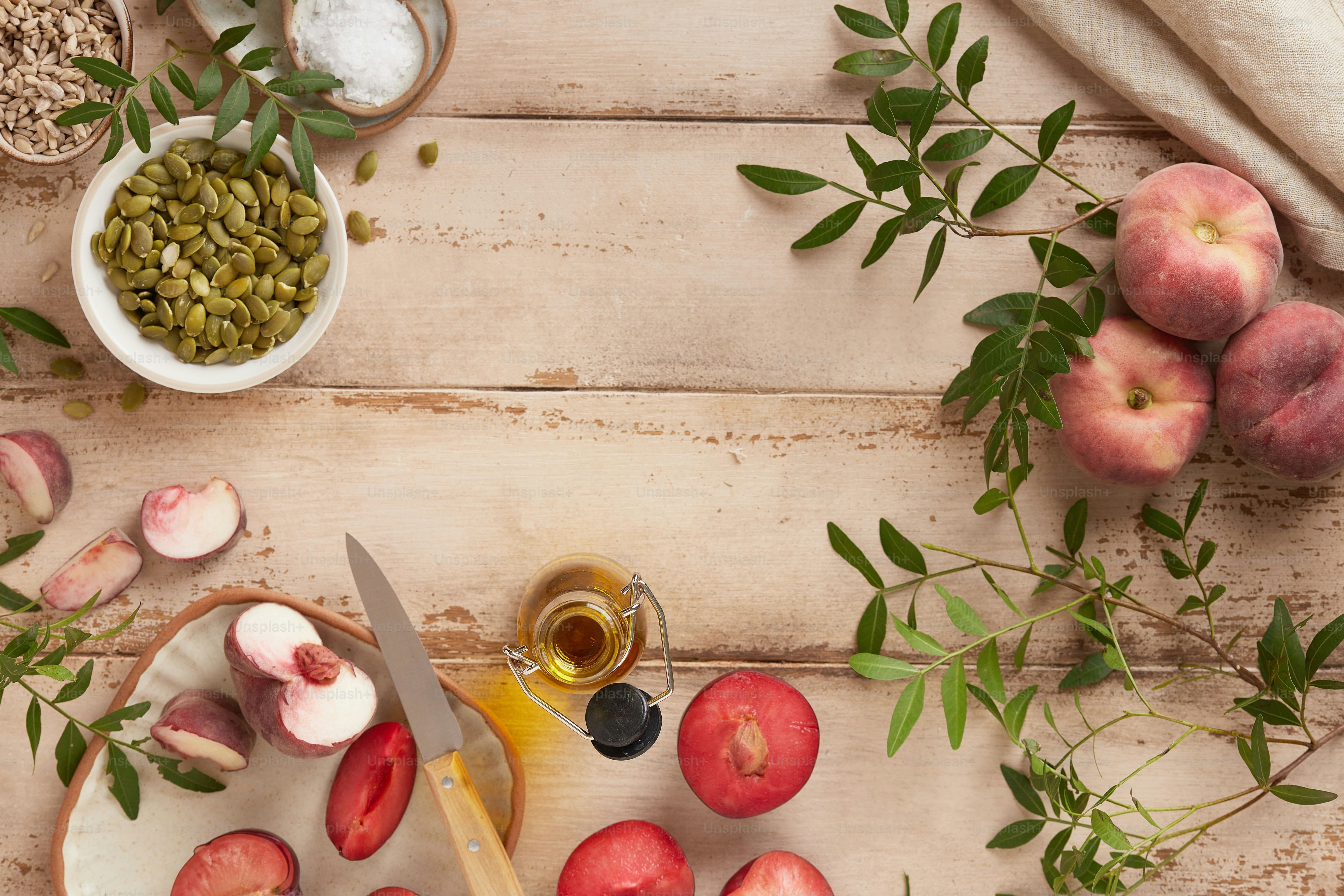 a wooden table topped with apples and other fruits
