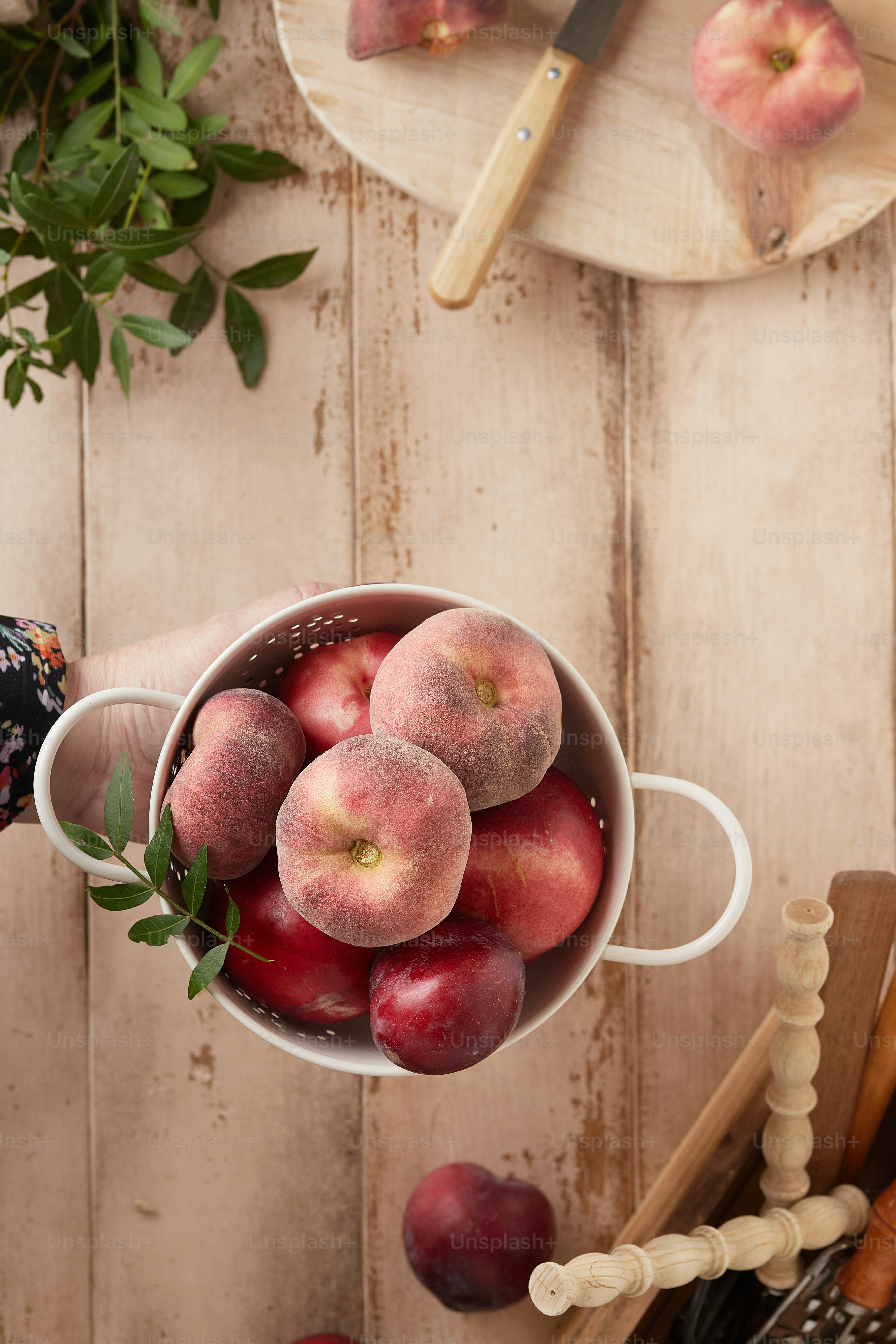 A person holding a bucket full of peaches photo Stone fruit Image on