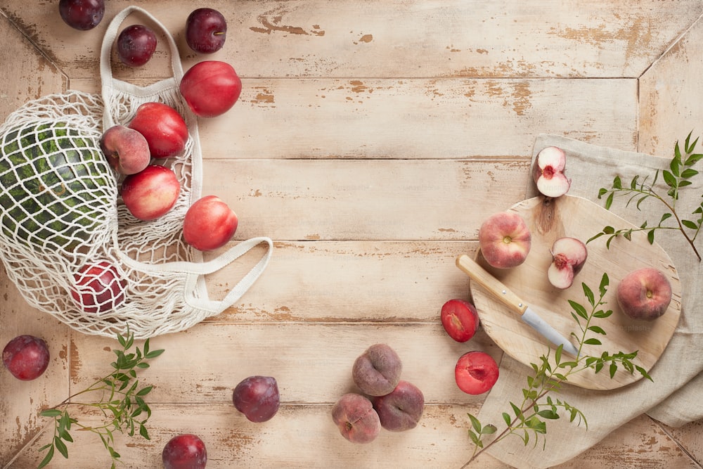 a wooden table topped with a bag of fruit