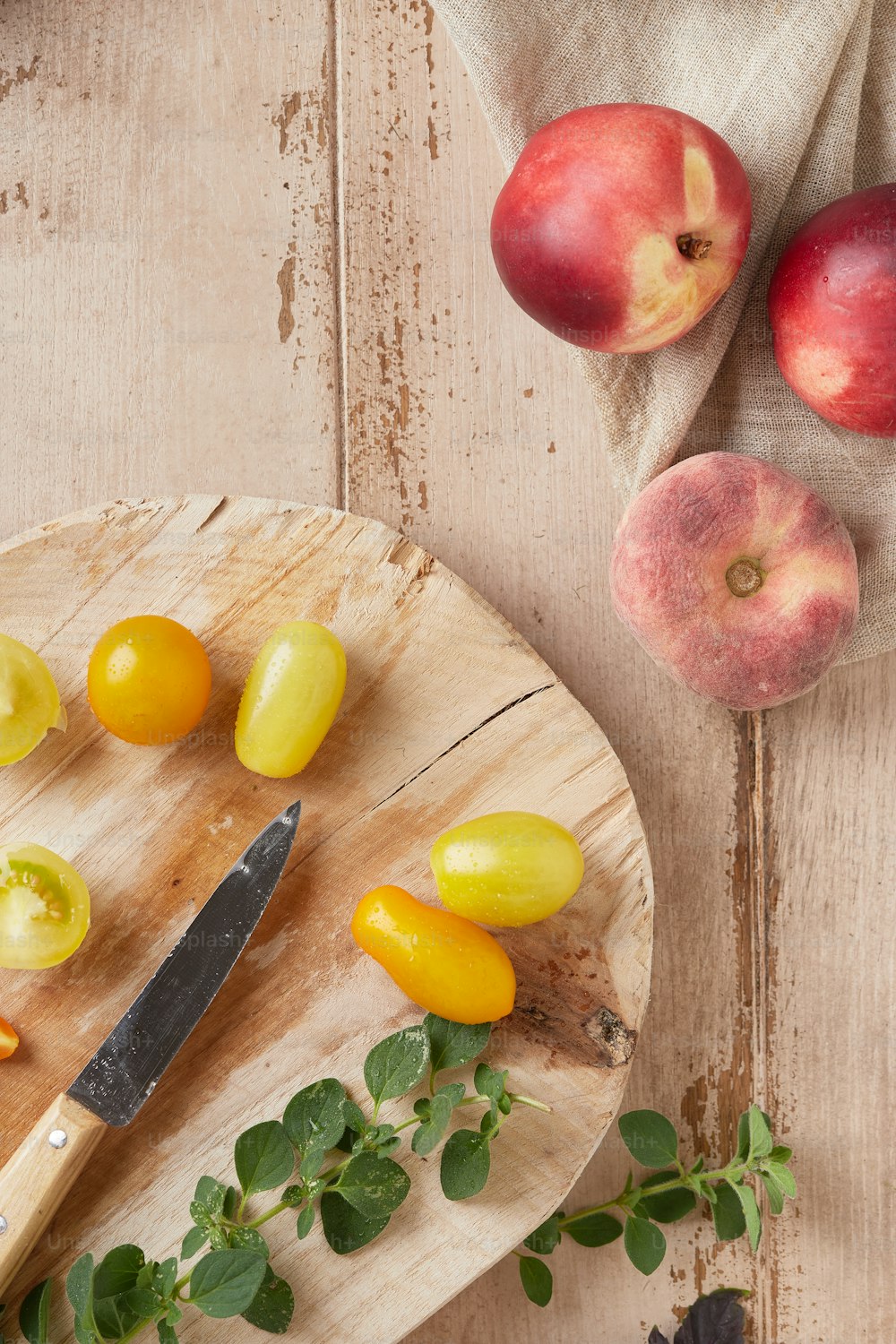 a cutting board with a knife and some fruit on it