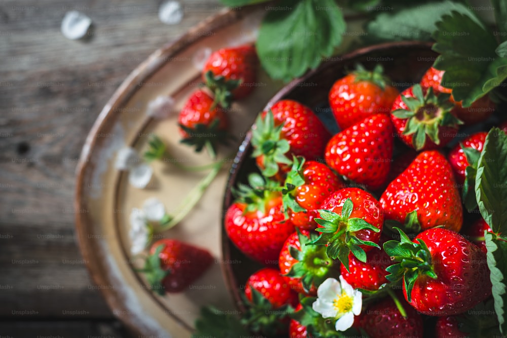 a bowl filled with lots of ripe strawberries