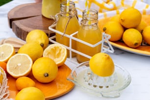 a table topped with oranges and bottles of lemonade