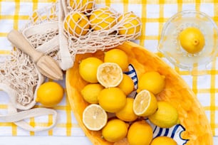 a bowl filled with lemons next to a bowl of lemons