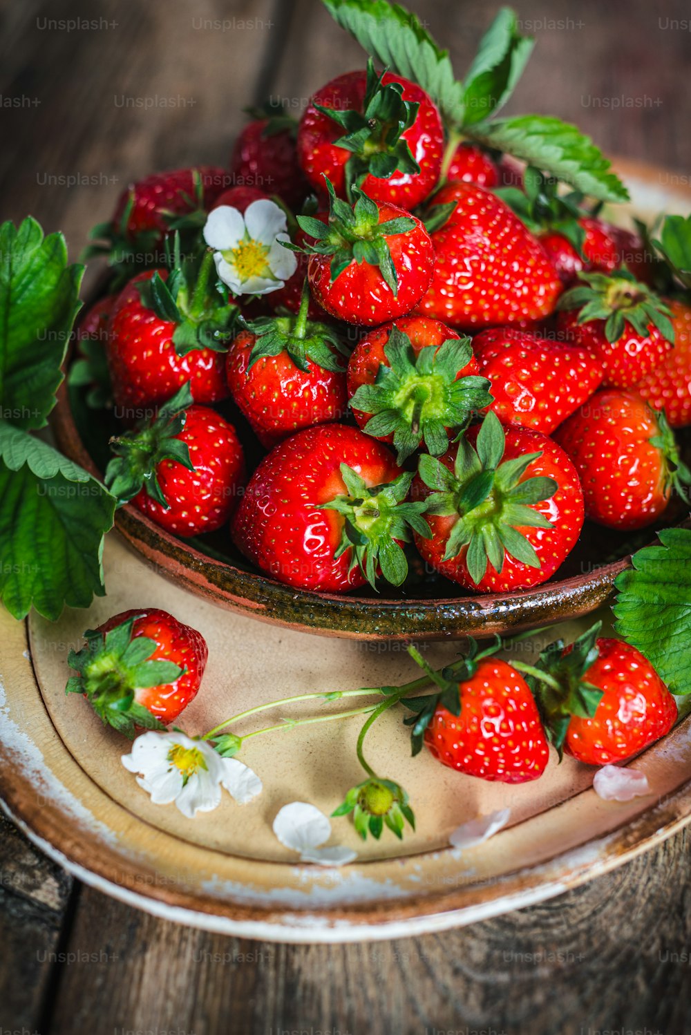 a bowl full of strawberries on a table