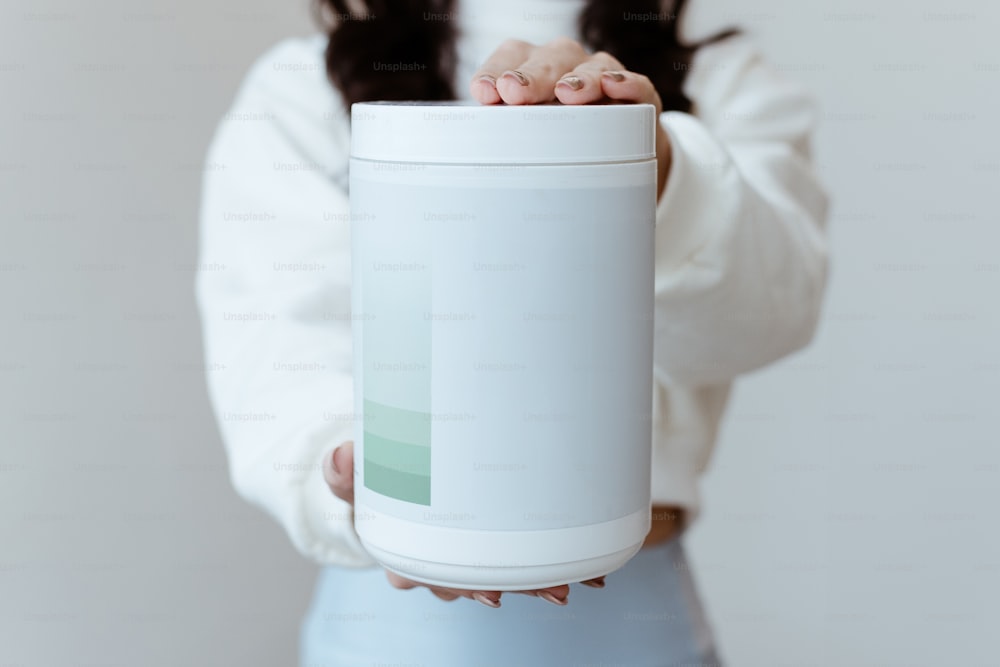 Una mujer sosteniendo una lata de refresco en sus manos