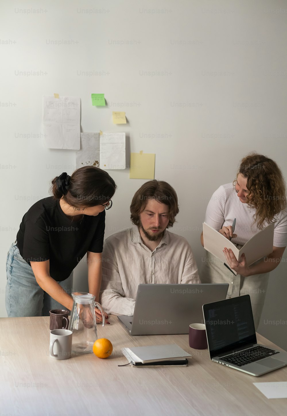 a man and a woman looking at a laptop