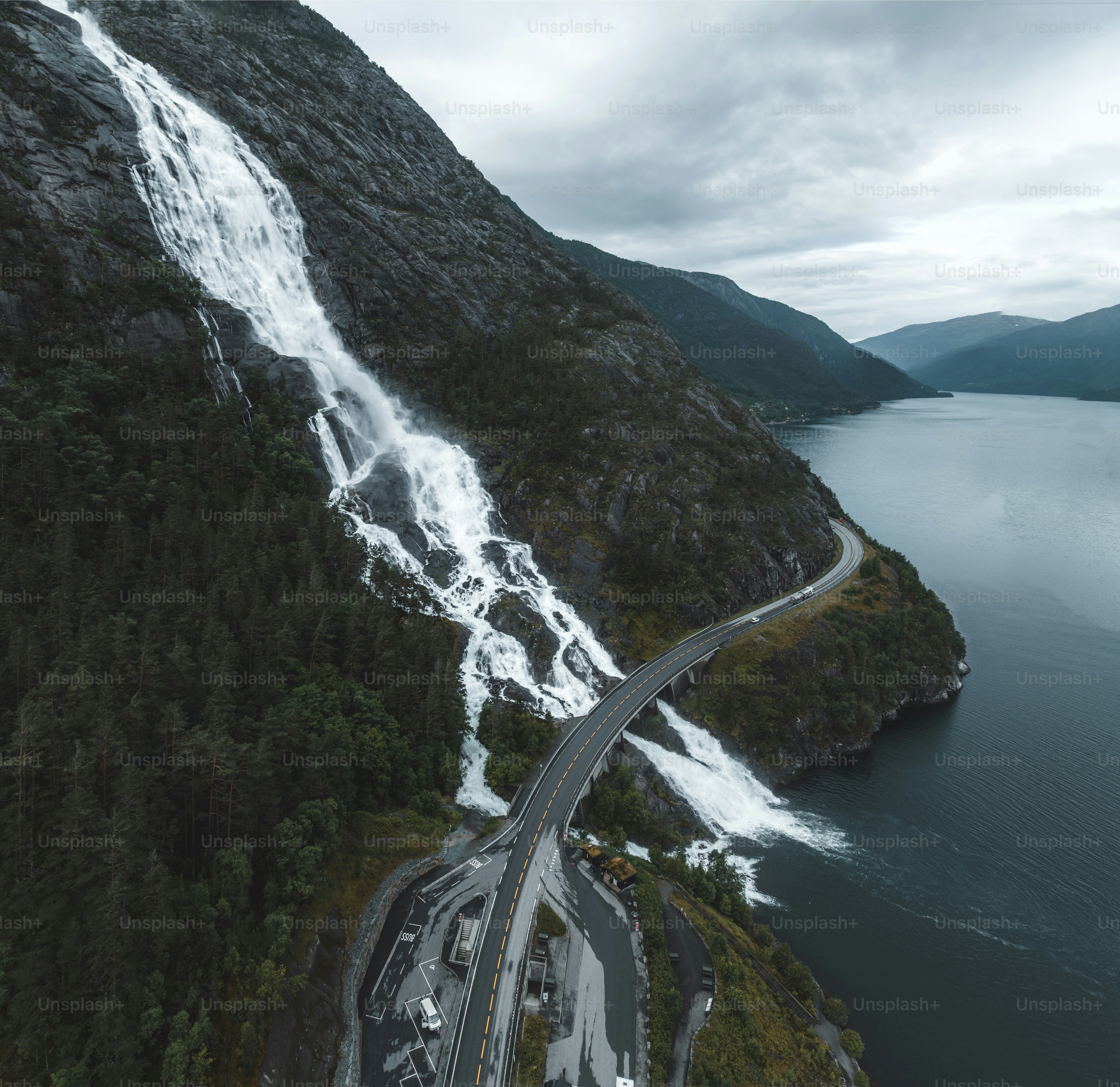 an aerial view of a highway near a waterfall