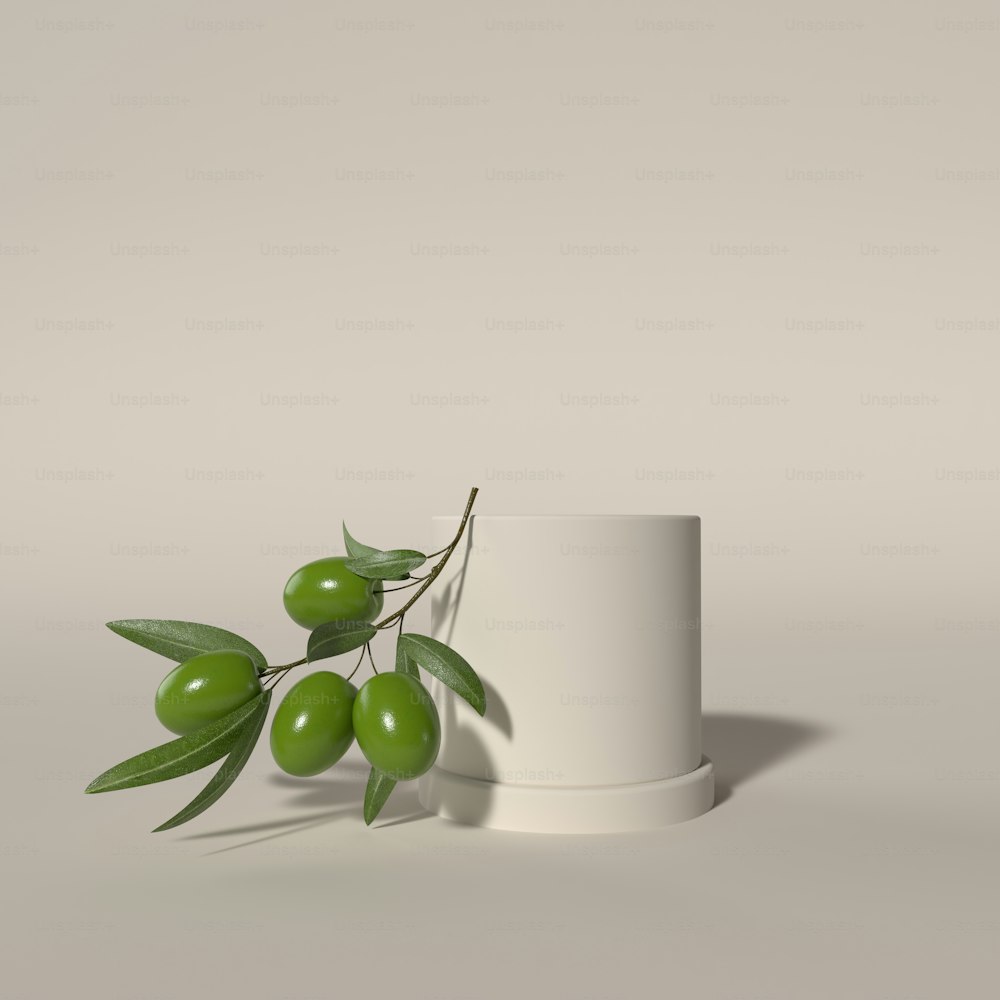 a white cup with some green olives on it